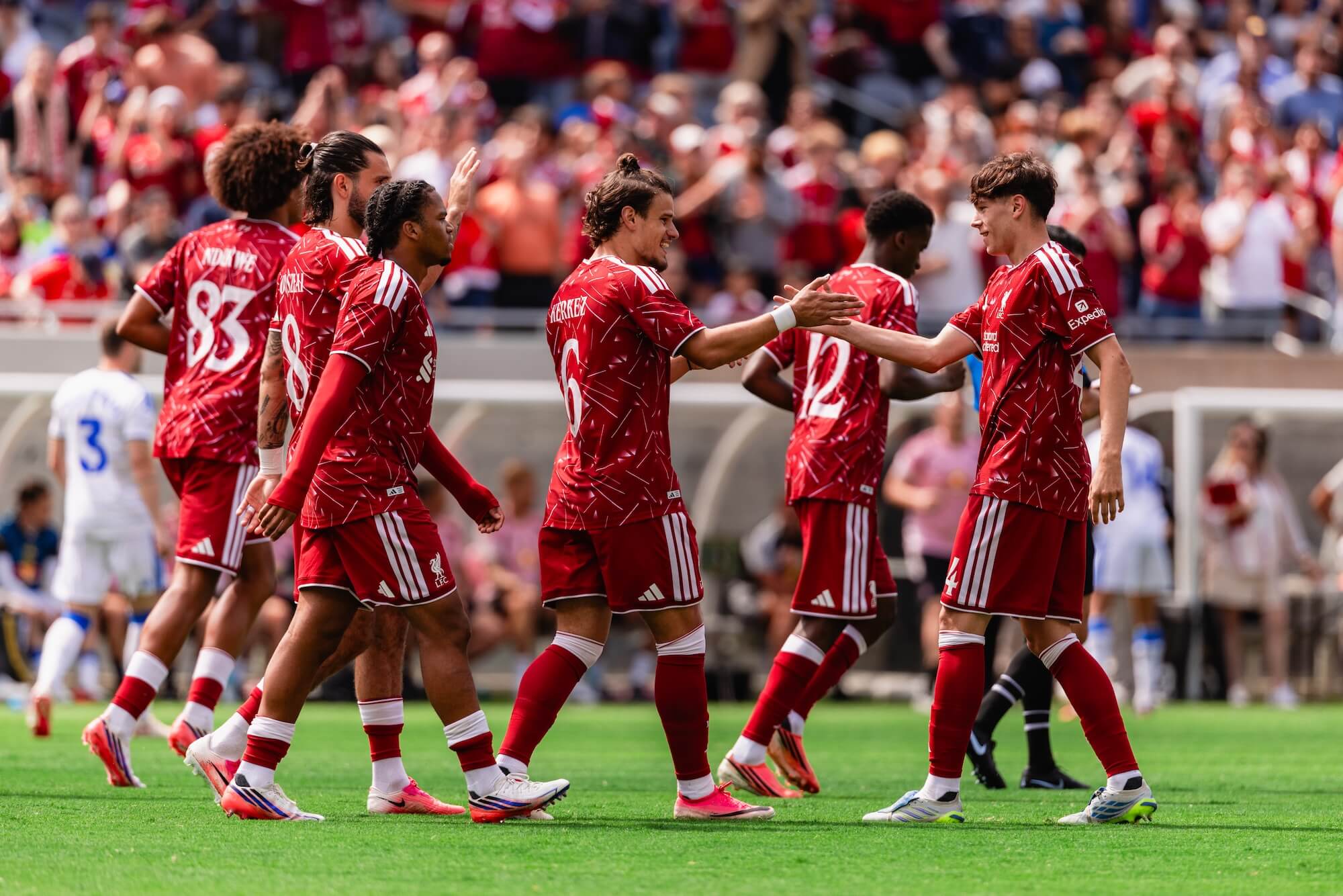 Liverpool FC players celebrating a goal together
